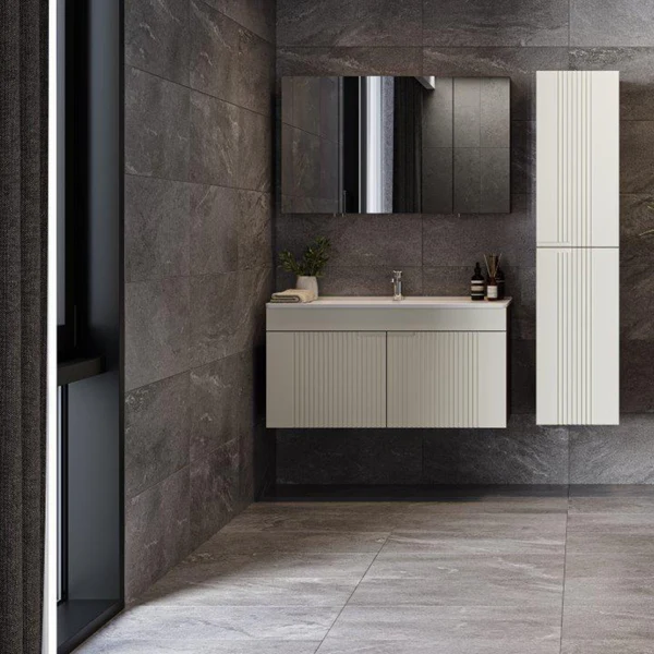 Dark charcoal gray stone-look porcelain wall tile in a modern bathroom with a floating vanity and tall storage cabinet. Etna Wall & Floor Tile.