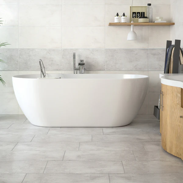 Luxor porcelain tile on bathroom walls and floor, featuring a modern freestanding bathtub and grey and white concrete-look finishes.