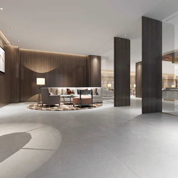 Sophisticated hotel lobby floor with large Texas Wall & Floor Tile in a light grey concrete-look finish, contrasting with dark wood walls.