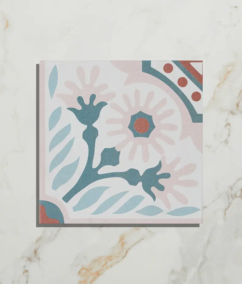 Cabana Porcelain Flamingo Tree 20x20cm tile close-up with a pink, teal, and terracotta floral quarter-pattern on a distressed white marble background.