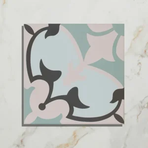 Cabana Porcelain Le Marais 20x20cm tile with a pale pink, blue, sage green, and black floral quarter-pattern on a light marble background.