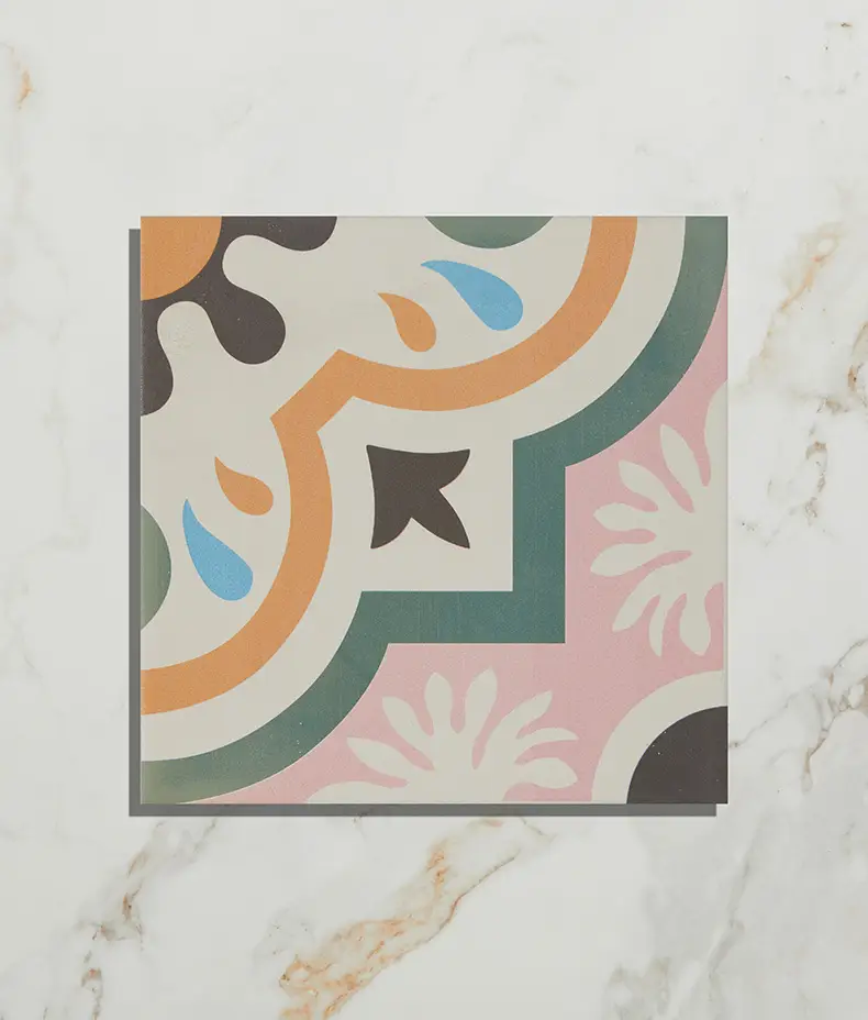 Cabana Porcelain New Orleans 20x20cm tile with a colorful pink, orange, green, and blue floral quarter-pattern on a light marble background.