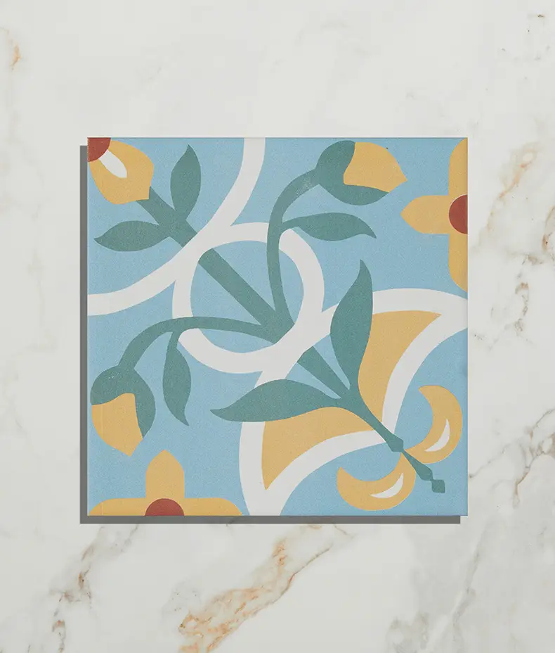 Cabana Porcelain Sicily 20x20cm tile with a colorful blue, yellow, and green floral pattern on a light marble background, shown close-up.