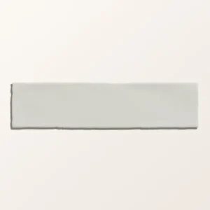 Carter Milk 7.5x30cm ceramic tiles with a handmade-look ripple texture and glossy, creamy white finish in a close-up photo.