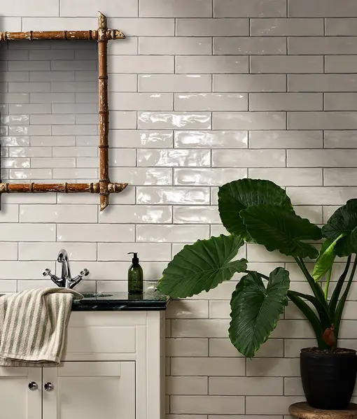Carter Milk 7.5x30cm ceramic subway tiles with a handmade-look ripple texture and glossy finish, used as a kitchen backsplash.