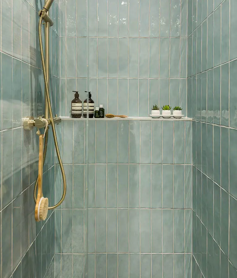 Carter Mint 7.5x30cm ceramic subway tiles with a handmade-look ripple texture and glossy finish, used as a kitchen backsplash.