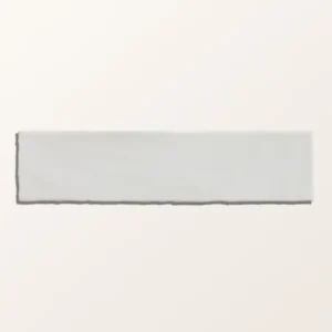 Carter White 7.5x30cm ceramic tiles with a handmade-look ripple texture and glossy, pure white finish in a close-up photo.
