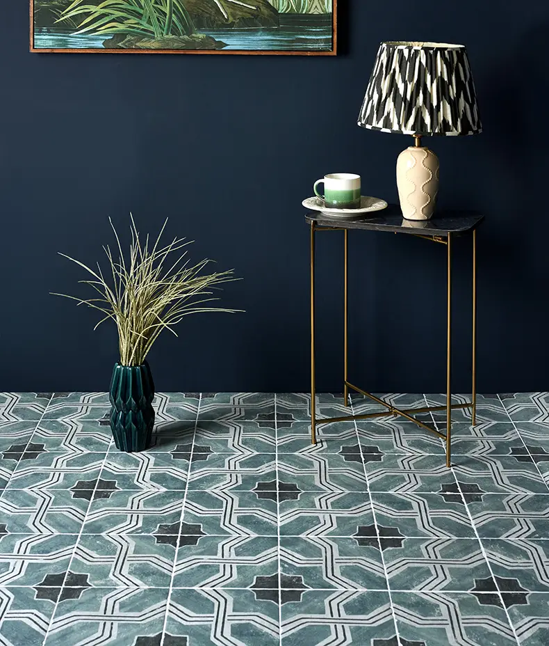Cuba Porcelain Iberia 20x20cm floor tiles with a distressed dark teal quatrefoil geometric pattern in a stylish room with navy walls and gold accents.
