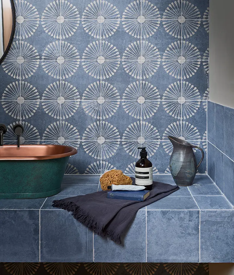 Cuba Porcelain Indigo Field 20x20cm tile covering a wall in a bathroom setting, surrounded by the Vedado Indigo pattern.