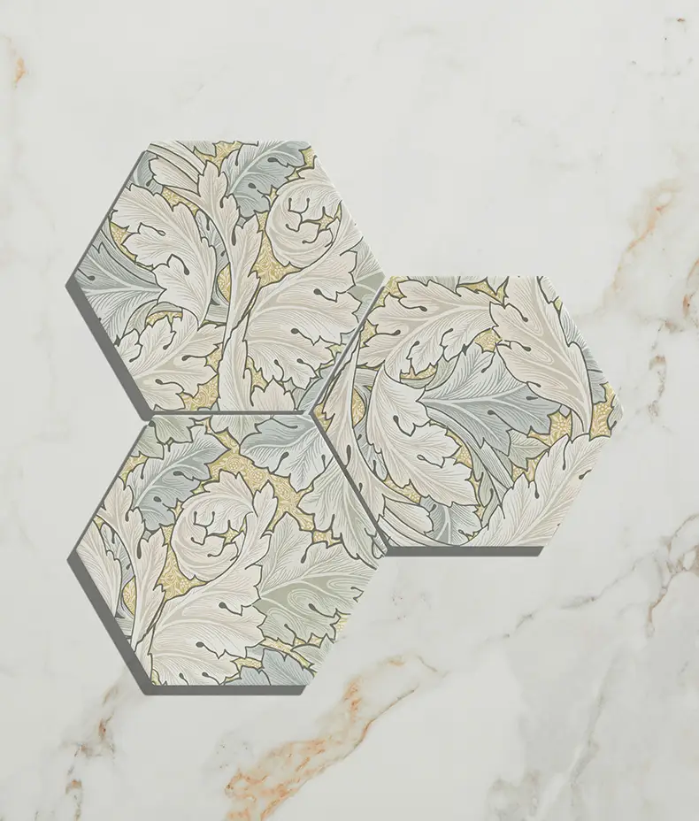 Folly Porcelain Sand Matt 20x23cm hexagonal tiles (three pieces) with a detailed beige, grey, and white leaf/acanthus pattern on white marble.