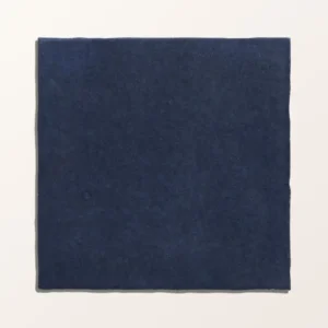 Maroc Porcelain Oltremare 9.9x9.9cm tiles covering a kitchen backsplash, showcasing the rustic, faded dark blue finish and subtle surface variation.