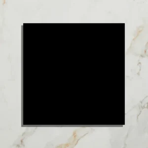Black square tile on white marble background.