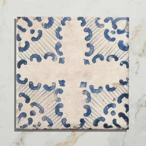 Sardinia Tarricone 20x20cm Porcelain Tiles on a bathroom wall above a chrome-legged sink, showcasing the geometric blue and white pattern.